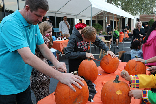 Halloween 2016 at TheeDigital - Raleigh Web Design and Digital Marketing - Parents and Kids carving pumpkins