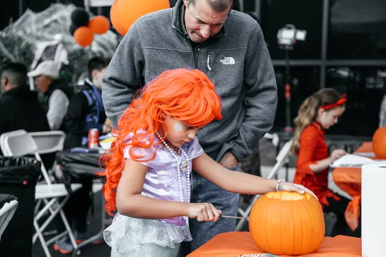 Child carving pumpkins