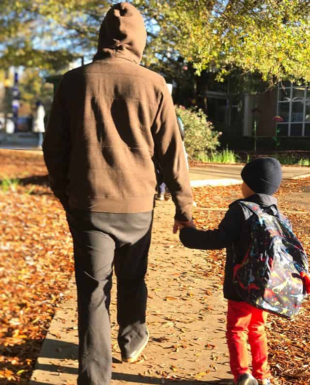 Picture of Christopher Lara walking on a sidewalk with his son